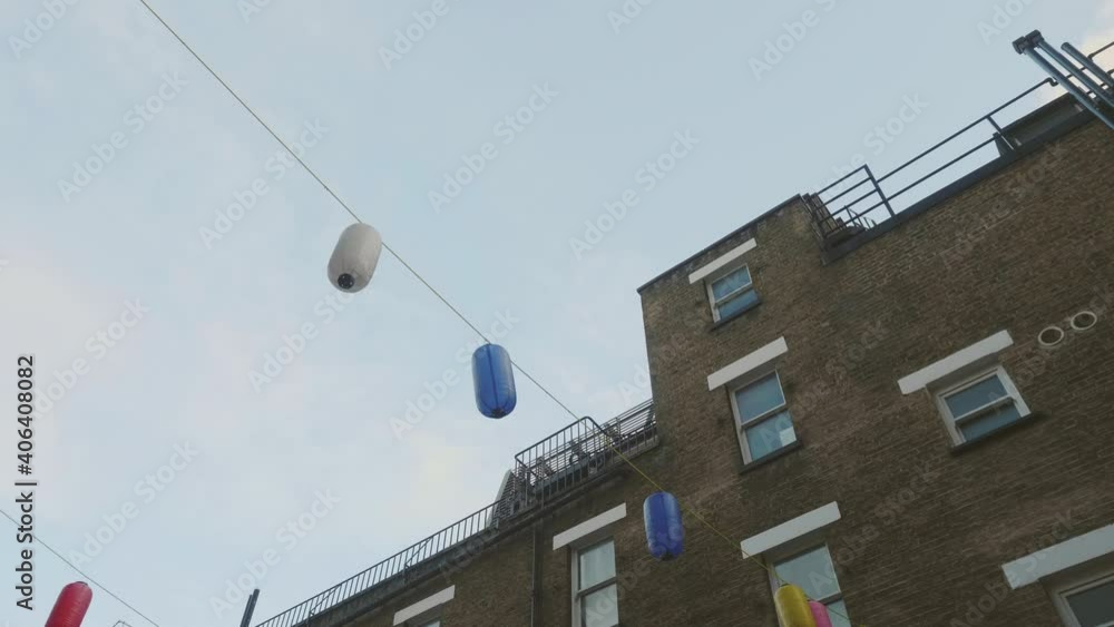 Chinese lamps dangling in the wind between houses in Chinatown, London. Chinese lamps dangling in the wind between houses in Chinatown, London.