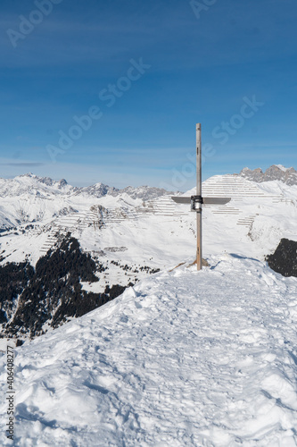 Gipfelkreuz: Aussichtspanorama über die verschneiten Berggipfel © Madeleine