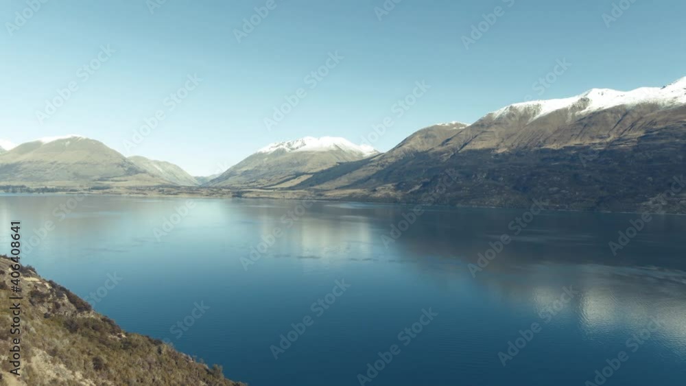 Drone pan over glacial lake surrounded by mountains in Winter New Zealand Drone pan over glacial lake surrounded by mountains in Winter New Zealand
