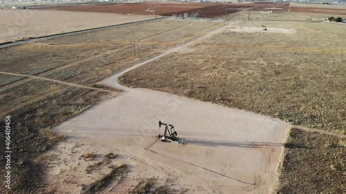 Located just outside the city of Midland, Texas there are just fields of Pumpjacks. Here is one! This shot features the vast desert around the pumpjack. photo