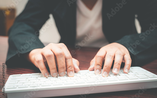 close-up of business woman hand typing and using laptop keyboard for searching with technology networking on working and job on desk at work place or work at home. © thithawat