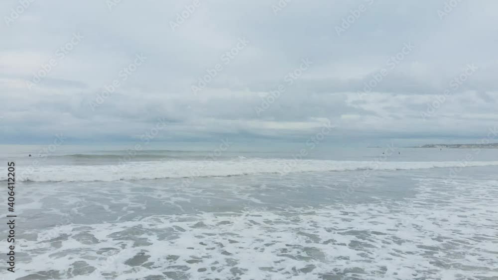 White water and waves on the beach with surfers in the distance. White water and waves on the beach with surfers in the distance.