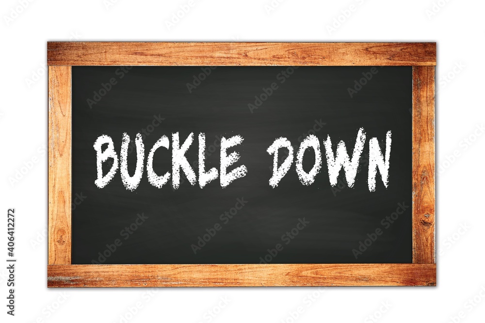 Fototapeta premium BUCKLE DOWN text written on wooden frame school blackboard.