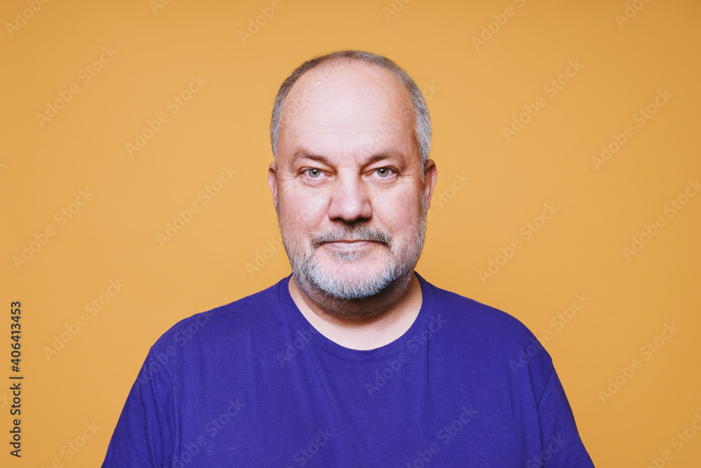 portrait of senior man with with gray white hair and beard against orange color studio background portrait of senior man with with gray white hair and beard against orange color studio background