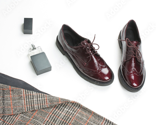 Checkered classic jacket in a check and Burgundy women's brogues (Derby shoes) on a white background with accessories.