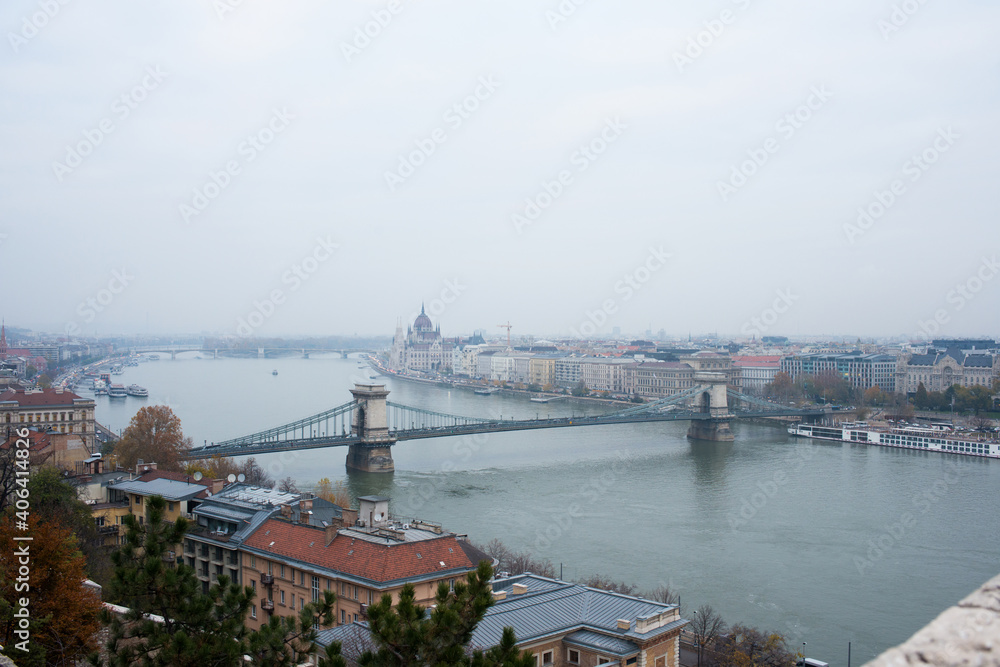 Panoramic view of Budapest from Royal Palace with river, bridge and parliament house on a cloudy day