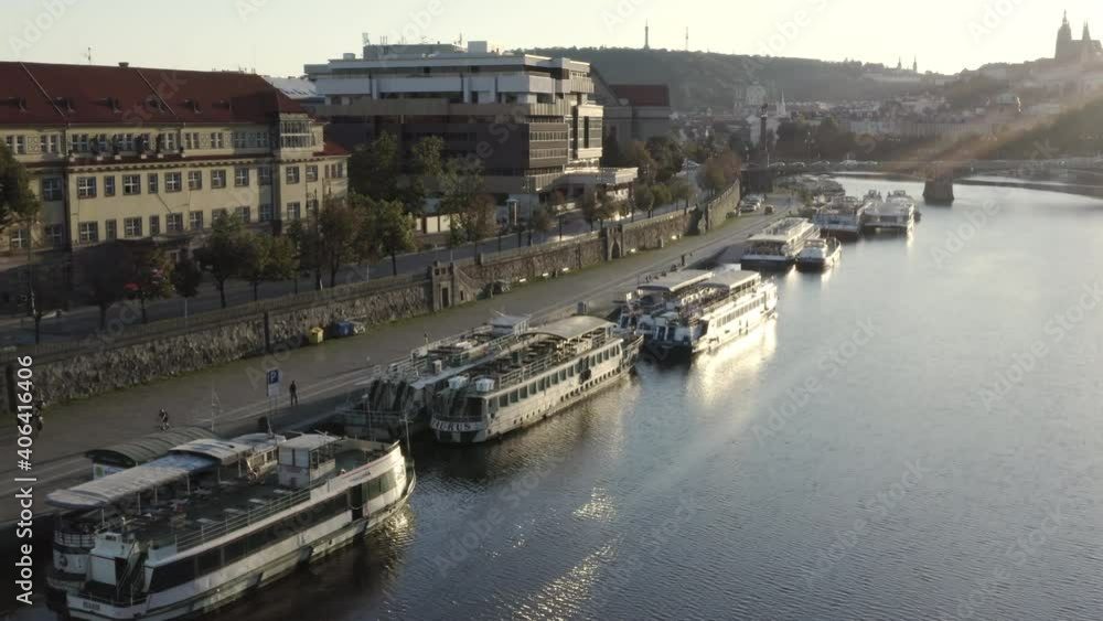 Boats anchored at a Vltava riverbank by a bridge,sunset,Prague,Czechia. Boats anchored at a Vltava riverbank by a bridge,sunset,Prague,Czechia.