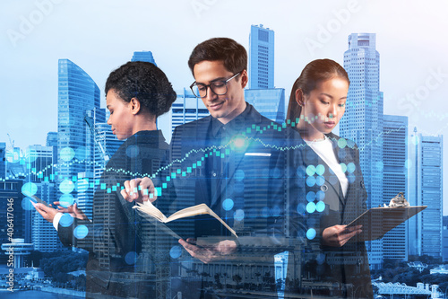 Group of business colleagues working on new venture capital and hi-tech start up and try to forecast risks and estimate prospective earning growth. Hologram chart on Singapore background.