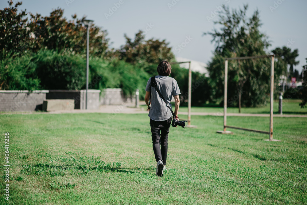 photographer man walks in the park photographer man walks in the park