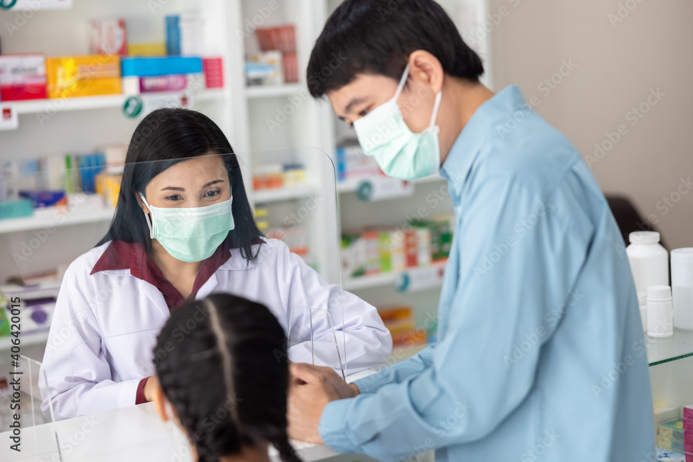 asian professional young women pharmacist wearing face mask while pescribing medicine to customer at drugstore Thailand covid-19 concept asian professional young women pharmacist wearing face mask while pescribing medicine to customer at drugstore Thailand covid-19 concept