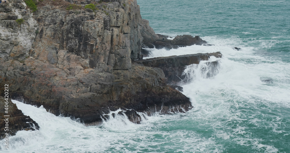 Sea waves splash against rock on island Sea waves splash against rock on island