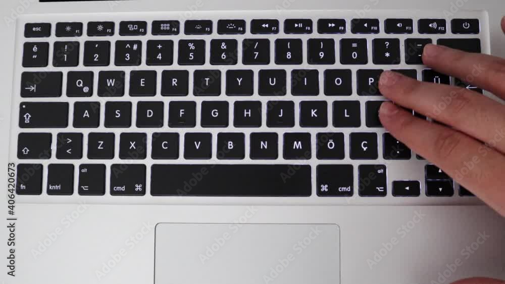 Full Top View Of A Laptop Keyboard With Hand Typing Apple Word And Press Enter Button, overhead shot Full Top View Of A Laptop Keyboard With Hand Typing Apple Word And Press Enter Button, overhead shot
