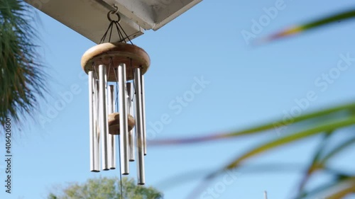 Calming and relaxing view of a wind chime blowing in a tropical garden photo