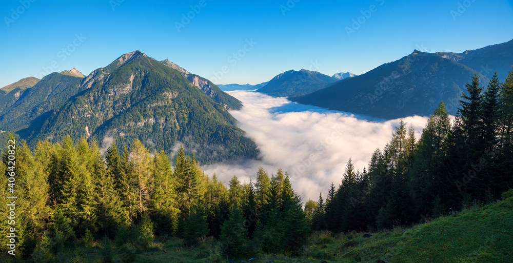 morning mist and foggy clouds over lake Achensee, view from Zwolferkopf mountain, austria