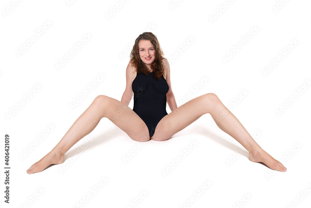 Smiling woman wearing a black swimsuit in front of white studio background