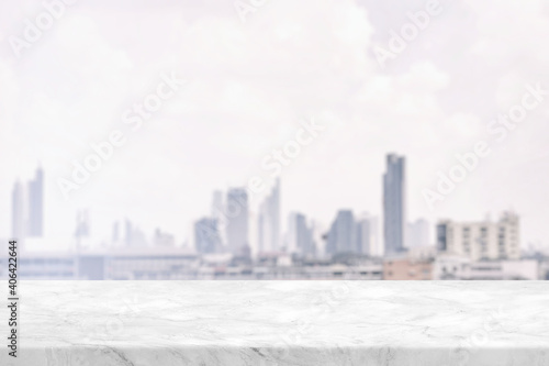 Marble Table with White Blurred Cityscape Background Background, Suitable for Product Presentation Backdrop, Display, and Mock up. © mesamong