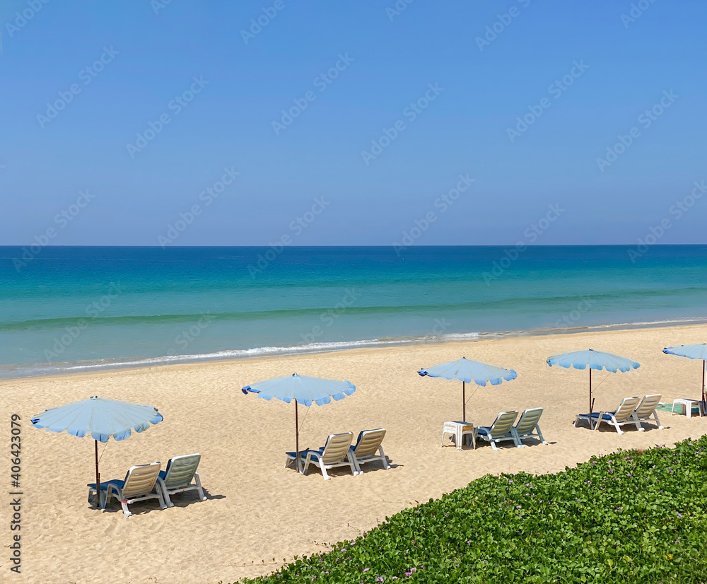 Beach with Beach beds on white clear sand, at Phuket, Thailand