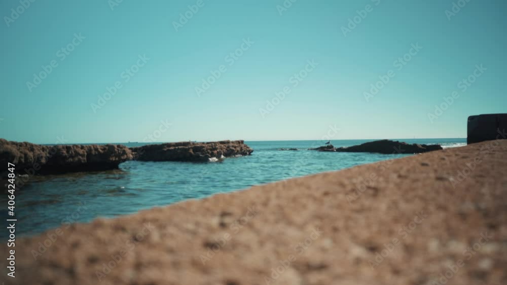 Ocean shoreline flat waves hit rocks at sunshine with seagul 4K Ocean shoreline flat waves hit rocks at sunshine with seagul 4K