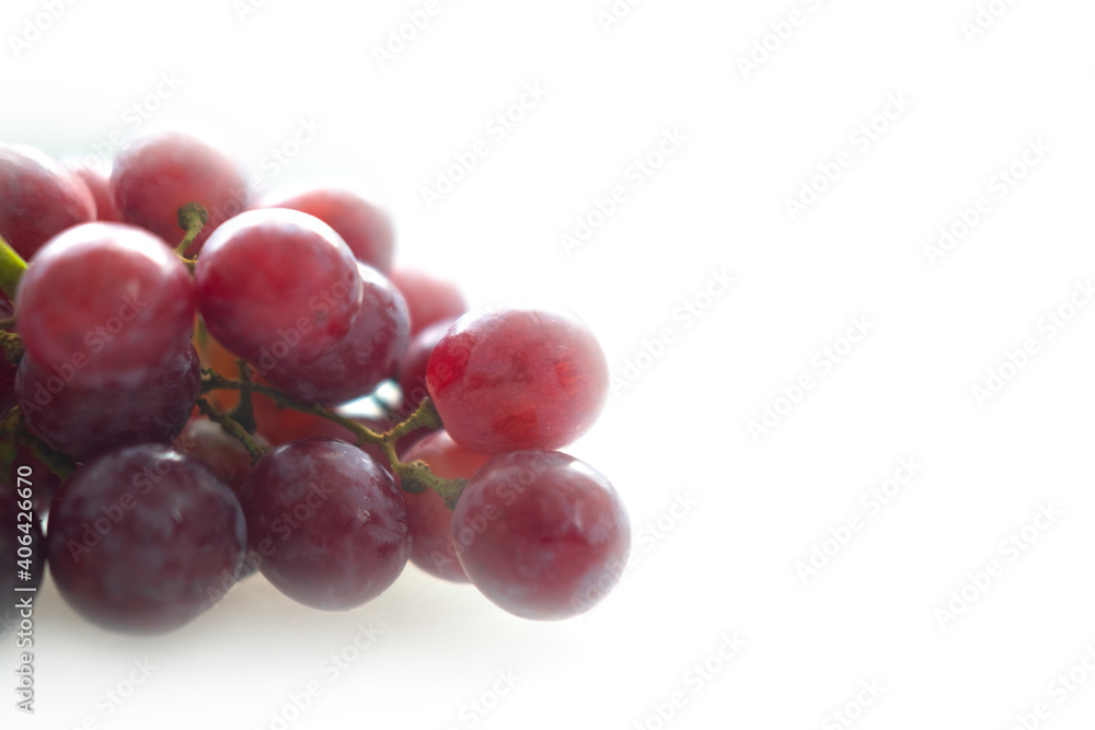 Ripe juicy red grapes on a white background