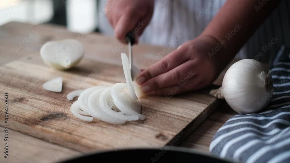 Chef cutting an onion with a knife. Chef cutting an onion with a knife.