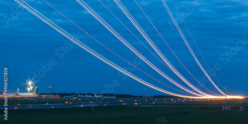Light trails at airport runway, Against cloudy blue sky at dusk