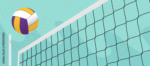colorful volleyball ball crossing the net in the open field photo