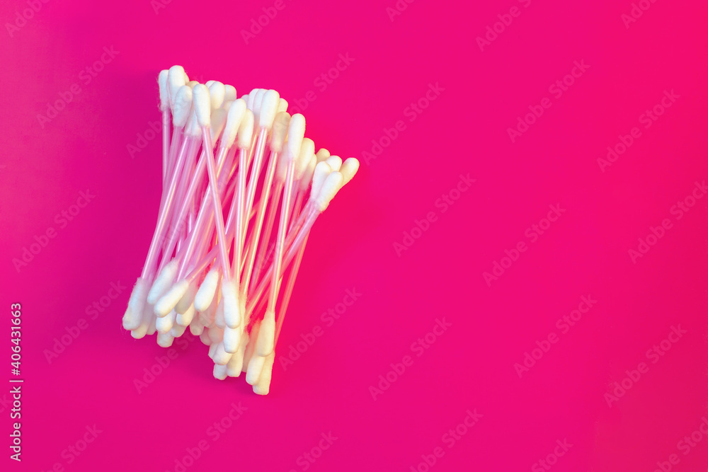 Cotton swabs made of white cotton on a pink background. Cotton swabs made of white cotton on a pink background.