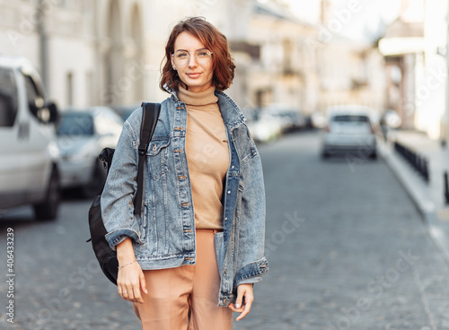 Stylish attractive woman in denim jacket on urban street © splitov27