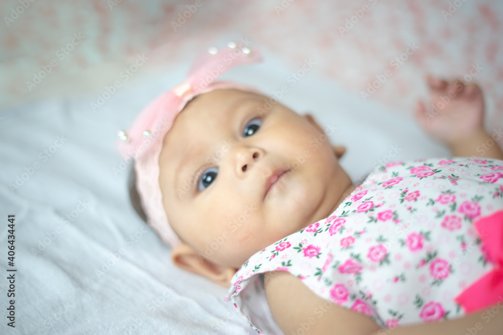 Healthy 3-4 Month Old Baby Girl looking up at Camera with multiple expressions Healthy 3-4 Month Old Baby Girl looking up at Camera with multiple expressions