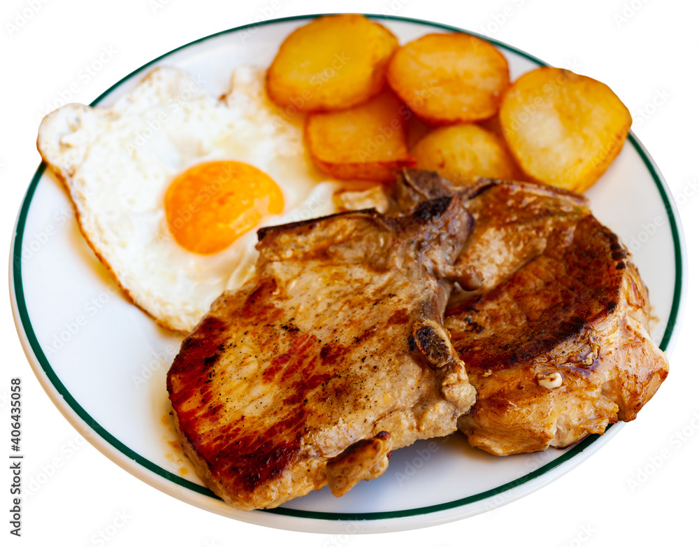 Appetizing pork chop with potatoes and scrambled eggs. Isolated over white background