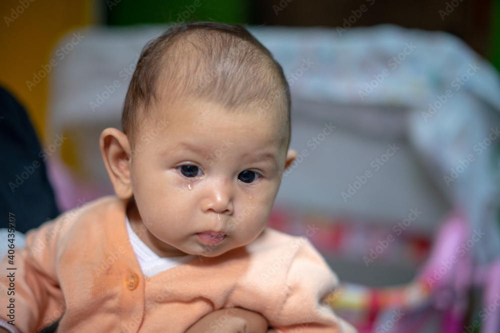 3 Month old baby girl with tears falling down her face 3 Month old baby girl with tears falling down her face