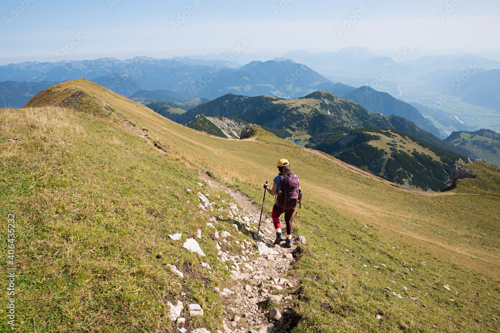 hiking young woman at the mountain ridge trail, Rofan mountains austria