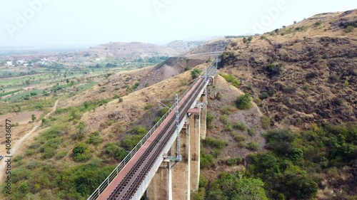 Aerial footage of a railway viaduct with electrification at Shindawane near Pune India. photo