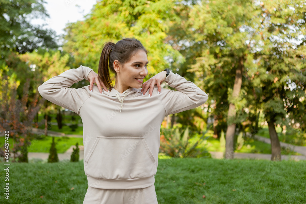 Young smiling fit woman warming up before training outdoors. Healthy lifestyle Young smiling fit woman warming up before training outdoors. Healthy lifestyle