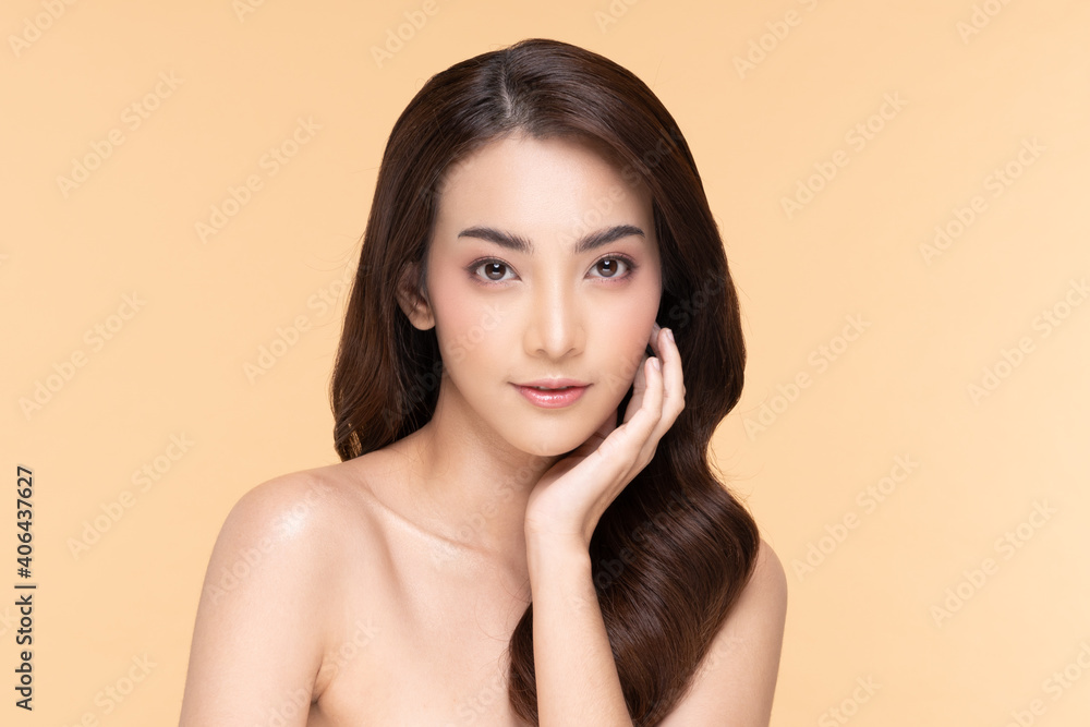 Beautiful Asian young woman touching soft cheek smile with clean fresh skin Happiness and cheerful with positive emotional,isolated on Beige background,Beauty Cosmetics and Facial treatment Concept Beautiful Asian young woman touching soft cheek smile with clean fresh skin Happiness and cheerful with positive emotional,isolated on Beige background,Beauty Cosmetics and Facial treatment Concept