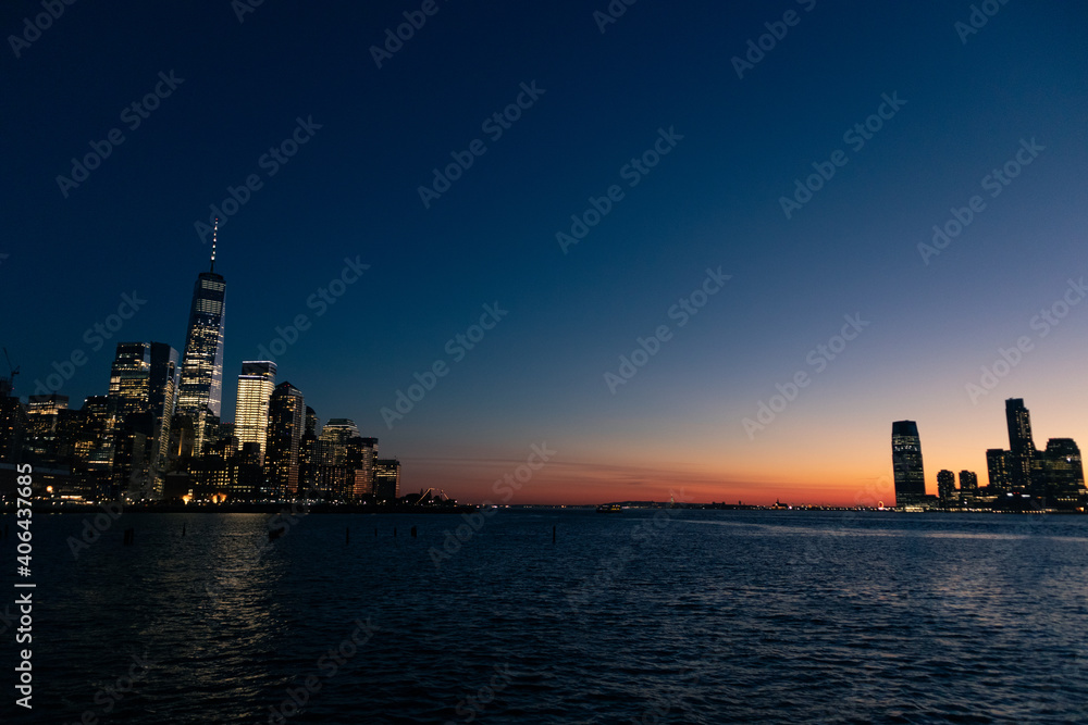 Evening on the Hudson River between the New York City and Jersey City Skyline after a Sunset