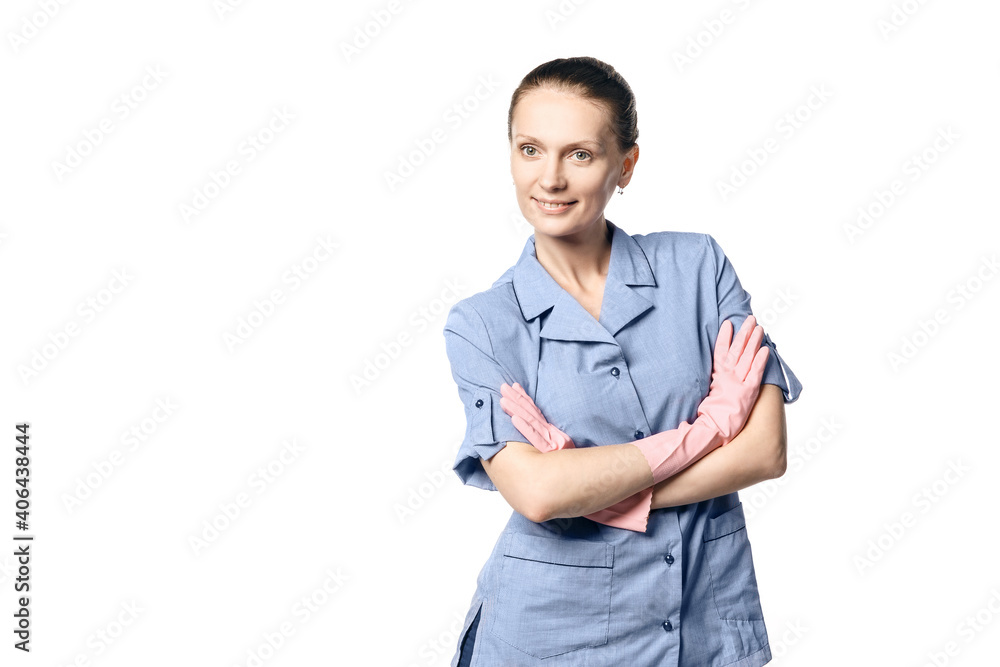 A beautiful young woman in the uniform of a maid smiling crossed her hands in rubber gloves on her chest. Isolated on a white background A beautiful young woman in the uniform of a maid smiling crossed her hands in rubber gloves on her chest. Isolated on a white background