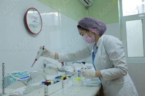 scientist looking at a microscope
