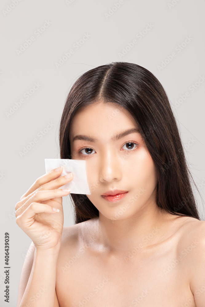 Attractive Charming Asian young woman smile and using tissue with toner for cleaning make up feeling so fresh and clean with healthy skin,isolated on white background,Beauty Cosmetics Concept Attractive Charming Asian young woman smile and using tissue with toner for cleaning make up feeling so fresh and clean with healthy skin,isolated on white background,Beauty Cosmetics Concept