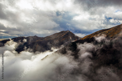 Mountain Marmagna peaks surrounded by clouds during autumn, Lagdei photo