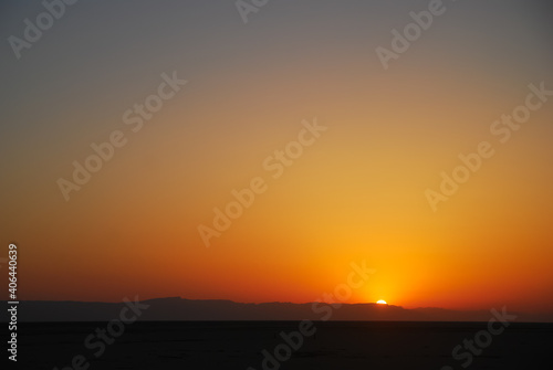 Sunset in Sahara Desert, Tunisia. View on Atlas Mountains © Dominik Kopycinski