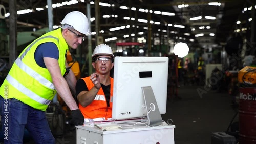 Manufacturing industry with technology. Engineers and technicians are working on industrial computers. Engineer manager command computer to produce products by automate machines in factory workshop. photo