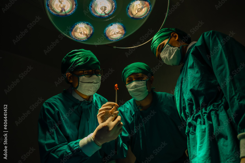 Fototapeta premium Group of asian doctor expert surgeons during a big surgery in surgical room.