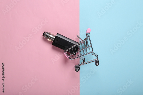 Shopping trolley with vaping device (electronic hookah or cigarette) on pink blue background. Top view