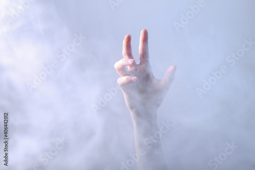 Hand in dense smoke. Mystical, Halloween theme