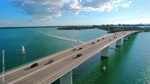Wallpaper Mural Following vehicle traffic over a water bridge in a tropical setting while boats pass underneath bridge Torontodigital.ca