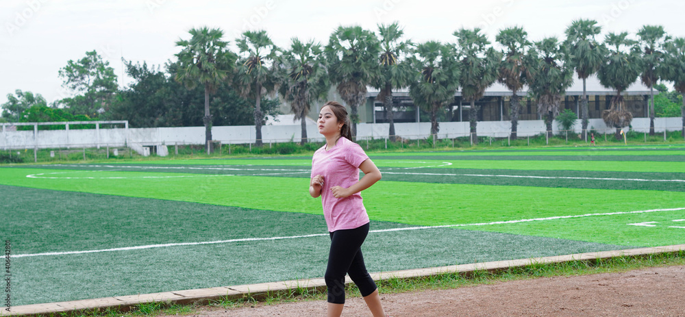 asian woman athlete running on track