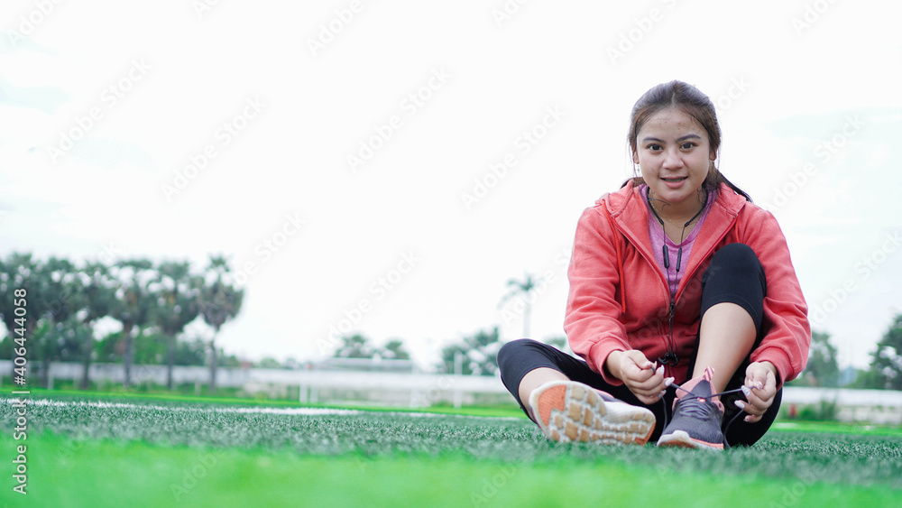 asian woman tying sneakers before running asian woman tying sneakers before running