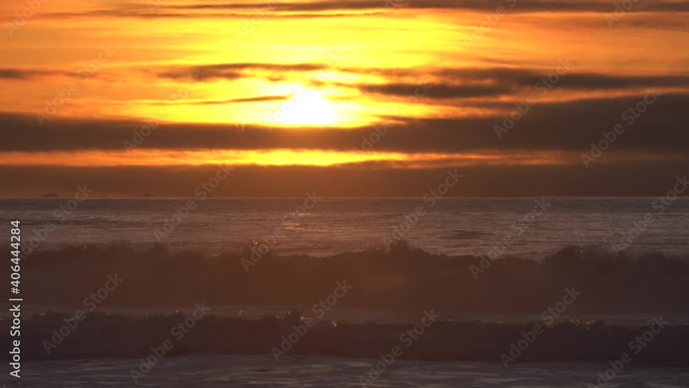 King Tides arrive on the Central Coast of California on January 10, 2021. Crashing sea waves over a sunset background with dark moving clouds. King Tides arrive on the Central Coast of California on January 10, 2021. Crashing sea waves over a sunset background with dark moving clouds.