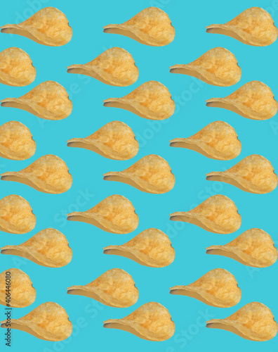 Background from potato chips. Isolate on a blue background. Junk food made from cholesterol. Salty and crispy. Fast food snack.